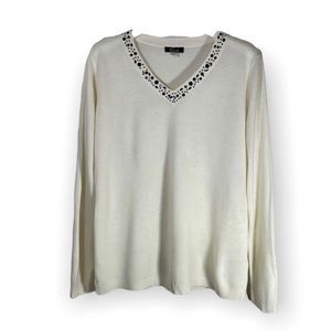 Cream colored long sleeve women’s sweater with with black sparkles in V-neck